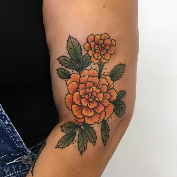 Traditional Marigold tattoo on the side of elbow
