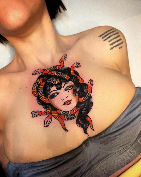 Traditional Medusa above boob tattoo