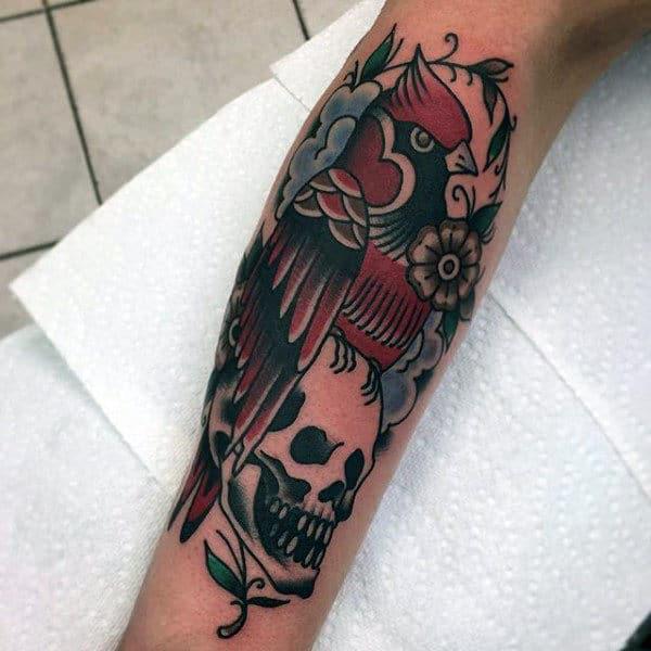 Traditional cardinal and skull forearm tattoo