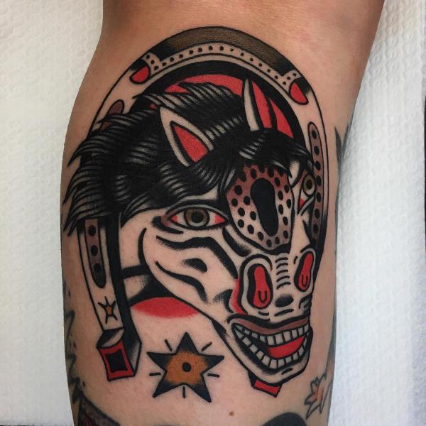 Traditional horse head with horseshoe tattoo