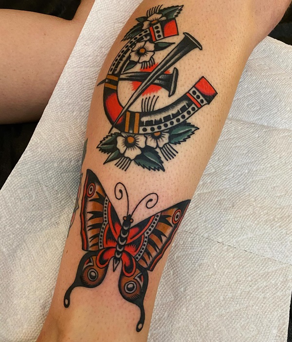 Traditional horseshoe and butterfly tattoo