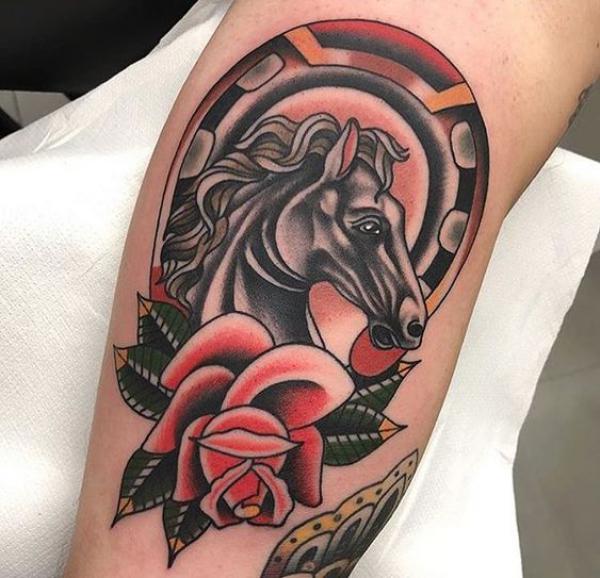 Traditional horseshoe and horse with rose tattoo