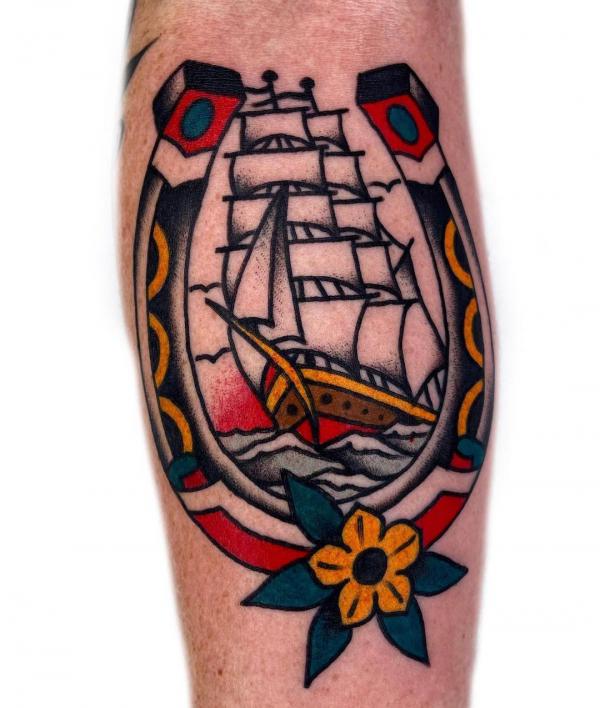 Traditional horseshoe and ship tattoo