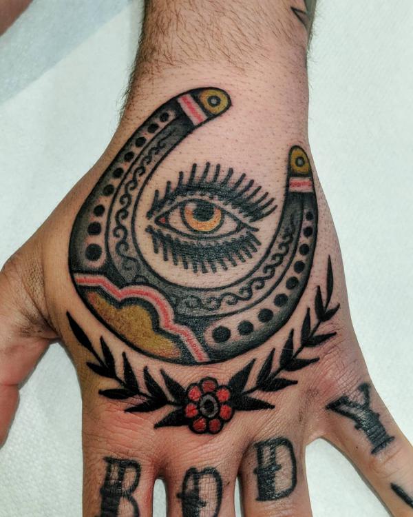 Traditional horseshoe with eye hand tattoo