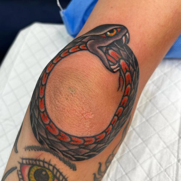 Traditional ouroboro elbow tattoo
