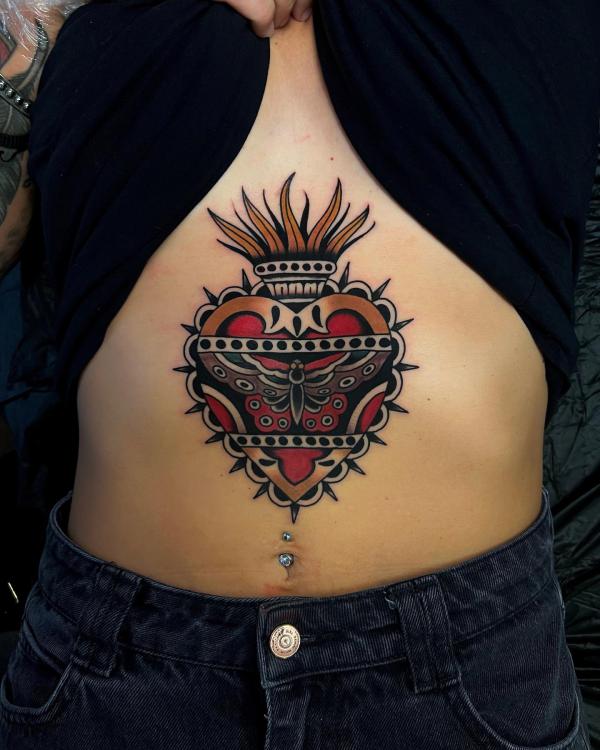 Traditional sacred heart underboob tattoo