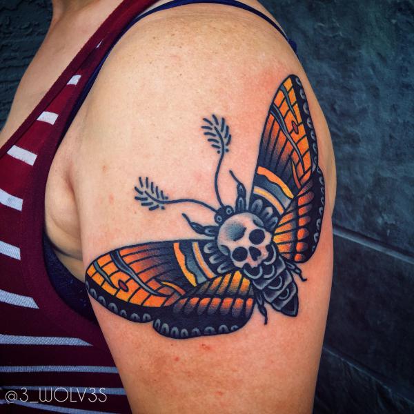 Traditional skull moth on upper arm
