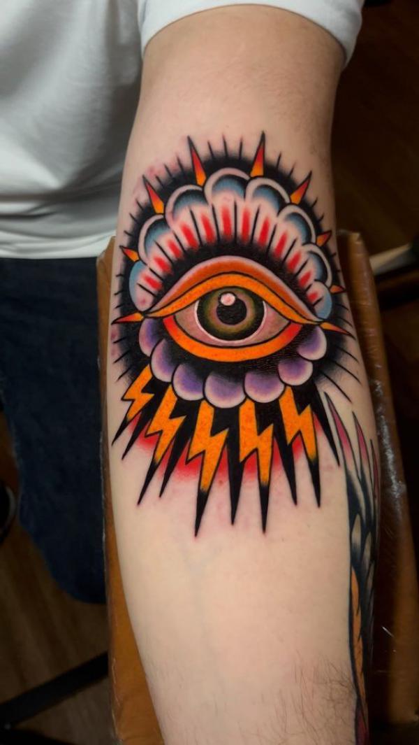 Traditional thunder eye elbow tattoo