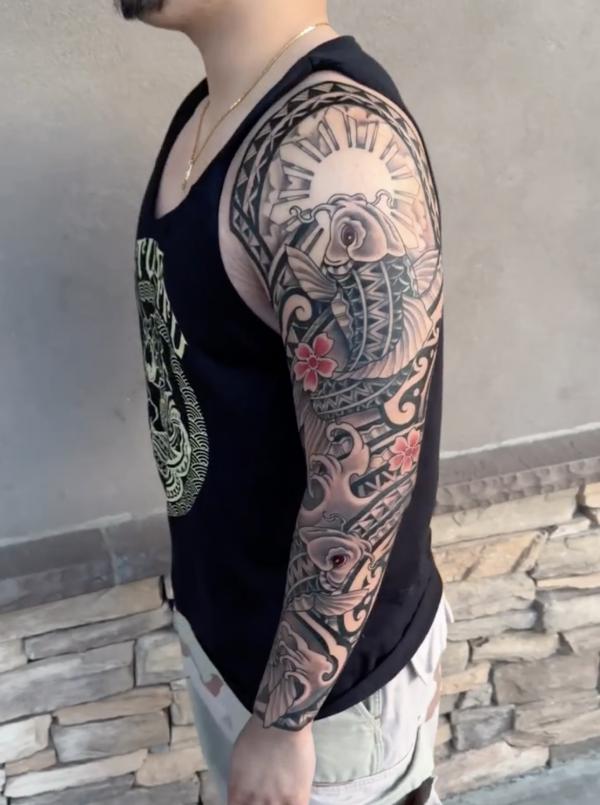 Tribal full sleeve with koi fish and wave tattoo