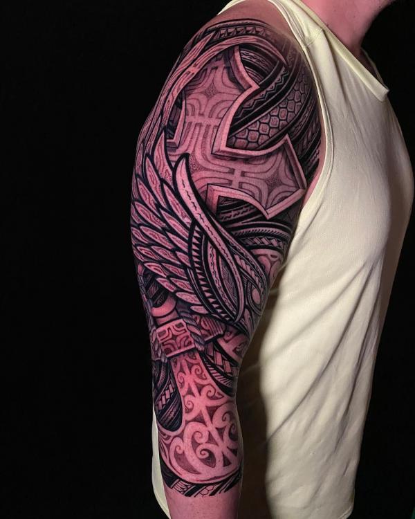 Tribal half sleeve with cross and wing tattoo