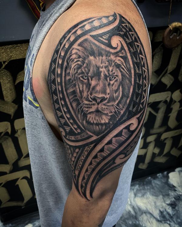 Tribal half sleeve with lion tattoo