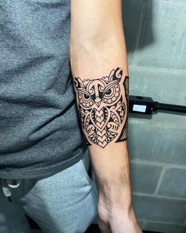 Tribal owl quarter sleeve tattoo