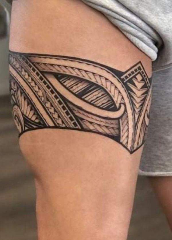 Tribal tattoo above knee