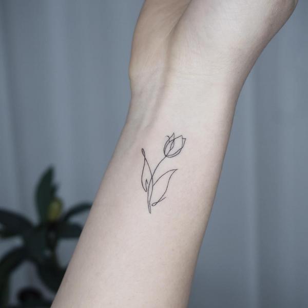 Tulip outline wrist tattoo