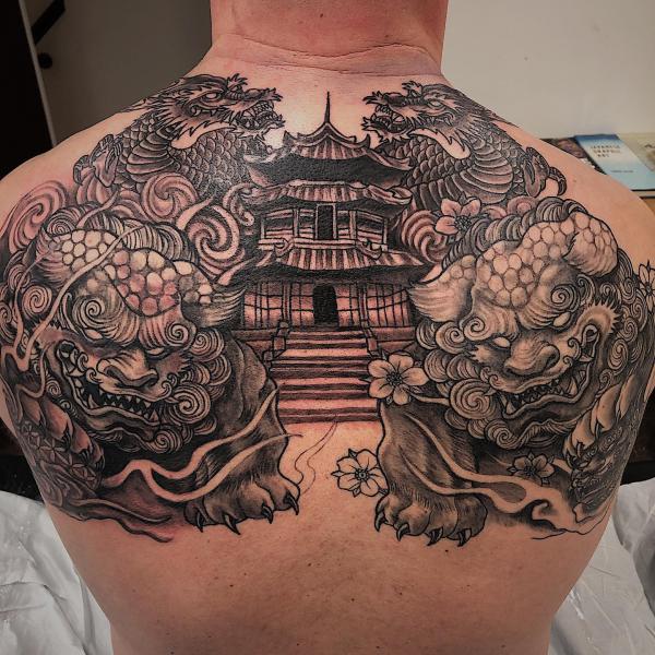 Two foo dog guarding a temple back tattoo