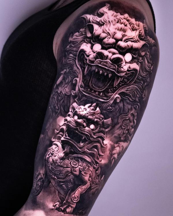 Two foo dogs half sleeve tattoo