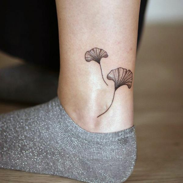 Two ginkgo leaf ankle tattoo black and grey