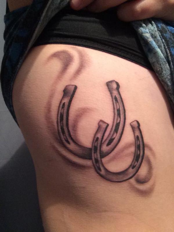 Two horseshoe thigh tattoo