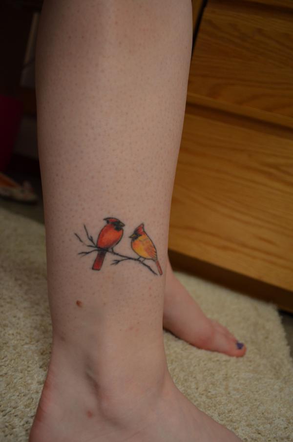 Two small cardinal tattoo above ankle