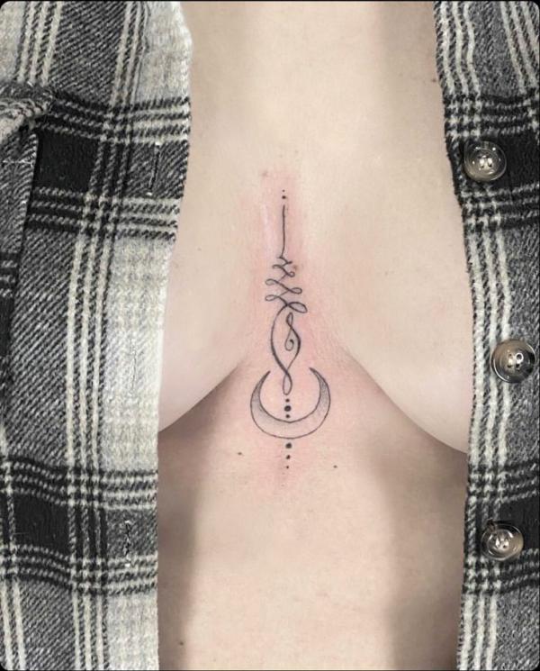 Unalome and crescent moon sternum tattoo