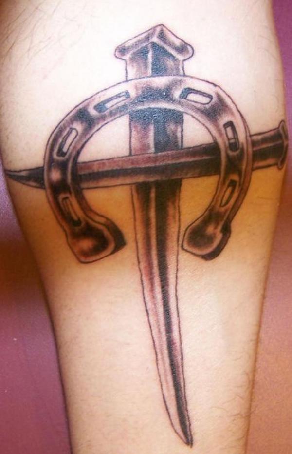 Vintage horseshoe and cross tattoo