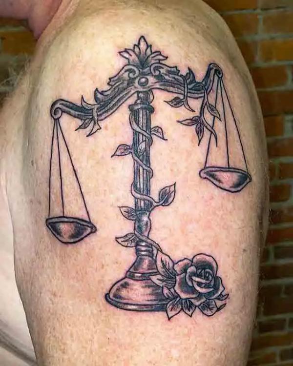 Vintage libra scale with rose tattoo