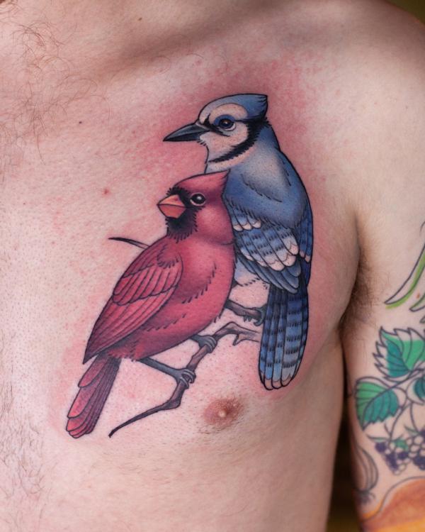Watercolor blue jay and cardinal tattoo on chest