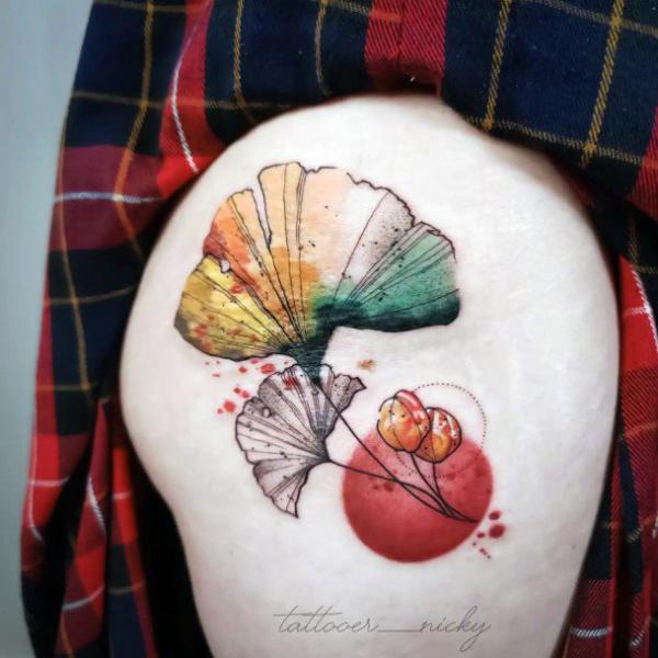Watercolor ginkgo tattoo on the side of hip