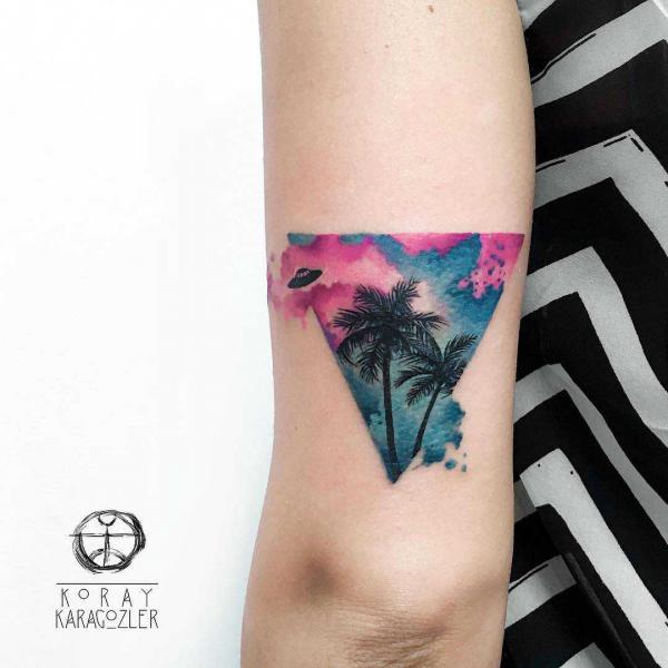Watercolor palm tree and UFO back of arm tattoo