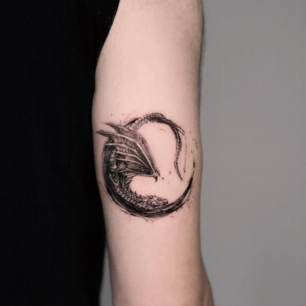 Western dragon circle back of arm tattoo