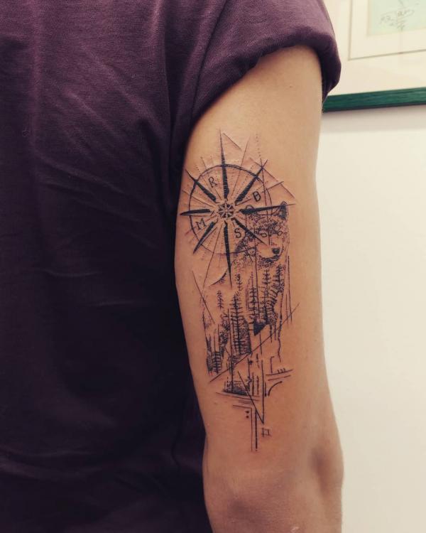 Wolf with wind rose and forest back of arm tattoo