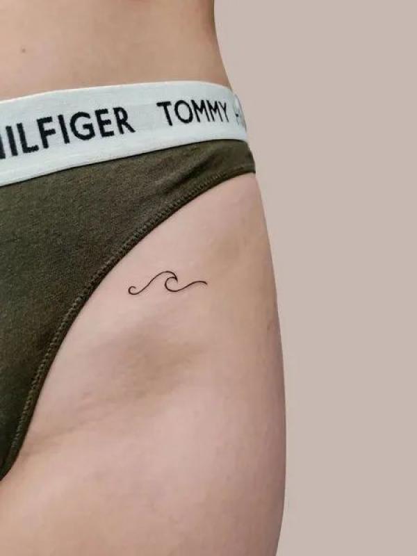 bikini line tiny wave tattoo