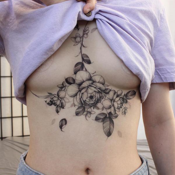 black and grey peony flowers sternum tattoo