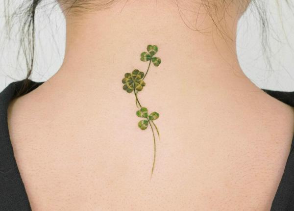 clover and shamrock tattoo on the back of neck