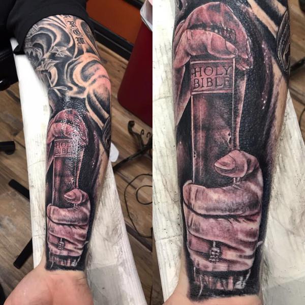 hands holding bible tattoo