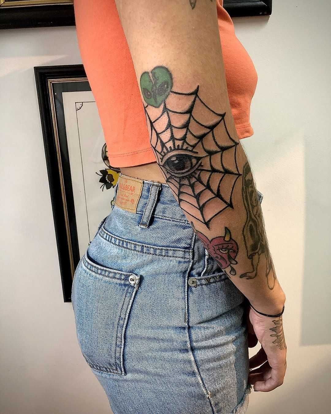 spider web with eye elbow tattoo
