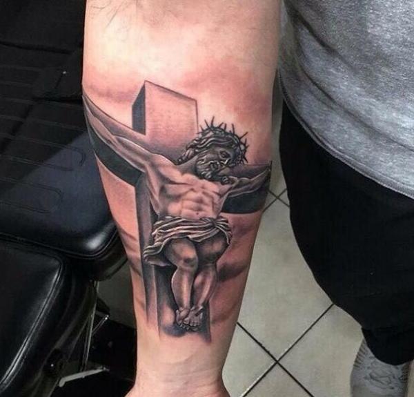 3D cross with Jesus tattoo on inner forearm