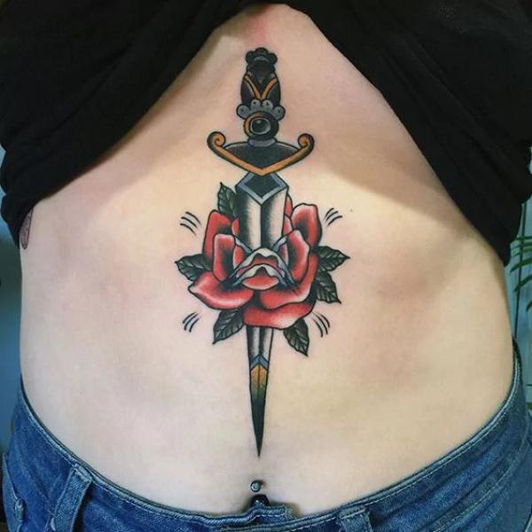A dagger through rose stomach tattoo