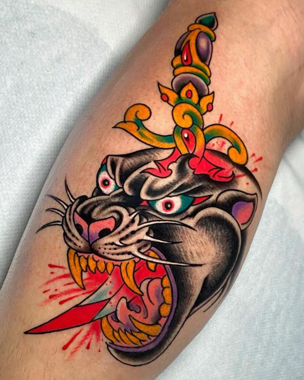 A knife through panther head tattoo traditional