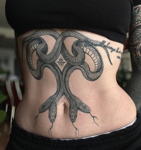 A pair of two head snake stomach tattoo