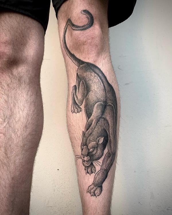 A prowling panther leg tattoo