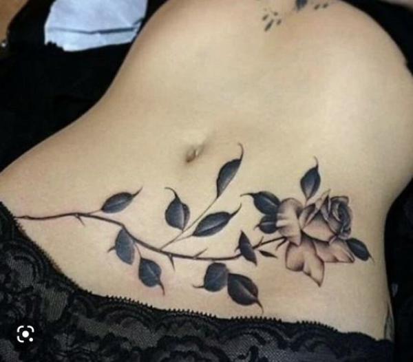 A stem of rose stomach tattoo