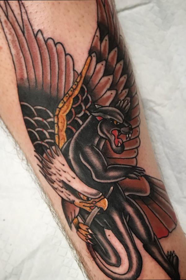 An eagle catching a panther tattoo