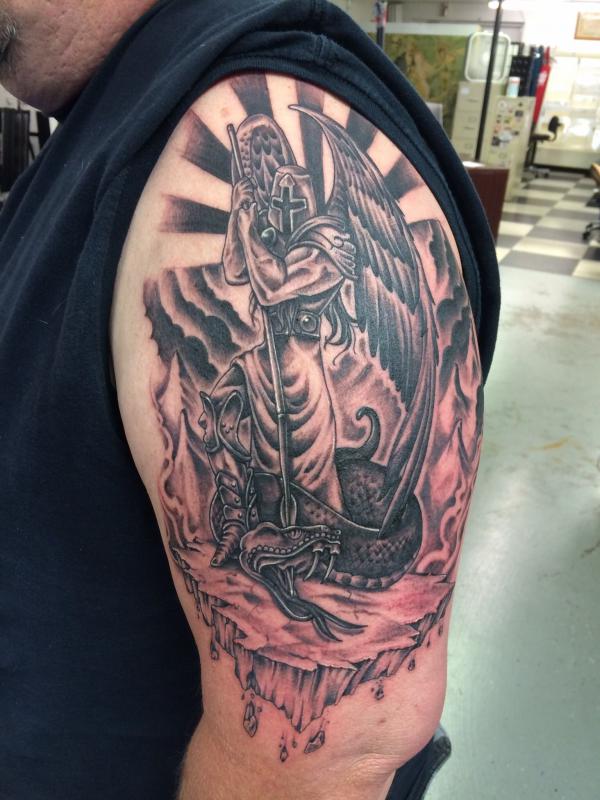 Archangel Michael fighting dragon half sleeve tattoo