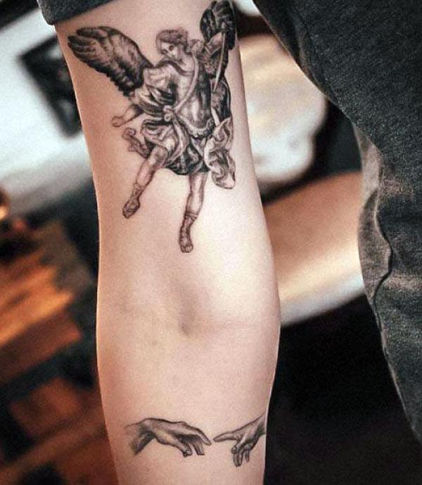 Archangel Michael tattoo above elbow