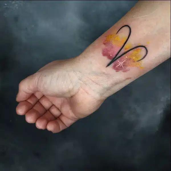 Aries glyph with star tattoo