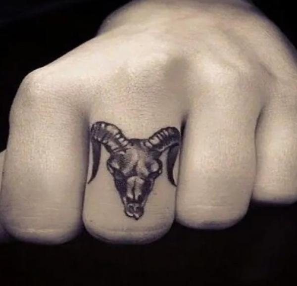 Aries ram middle finger tattoo