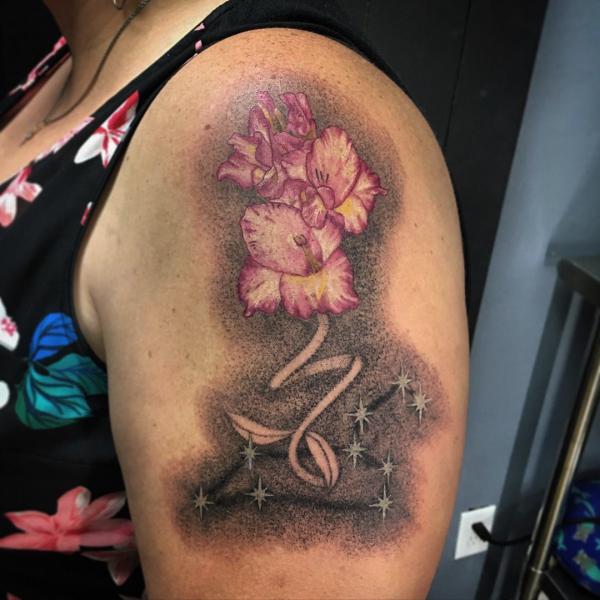 Astrological signs Capricorn and Leo gladiolus flower tattoo