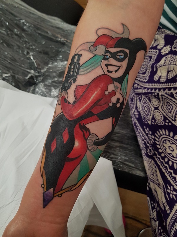 Batman Harley Quinn with gun tattoo forearm