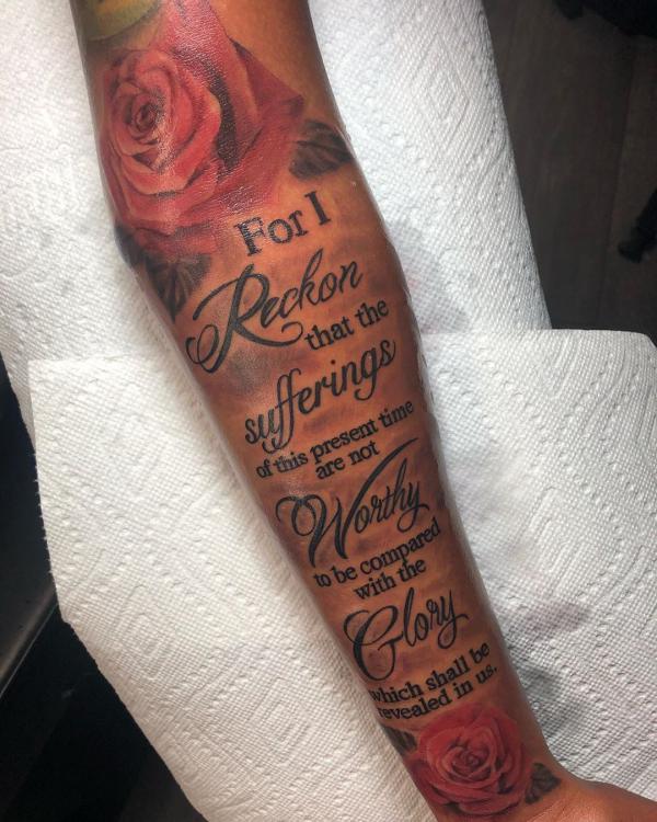 Bible verse Romans 8 18 with rose tattoo forearm